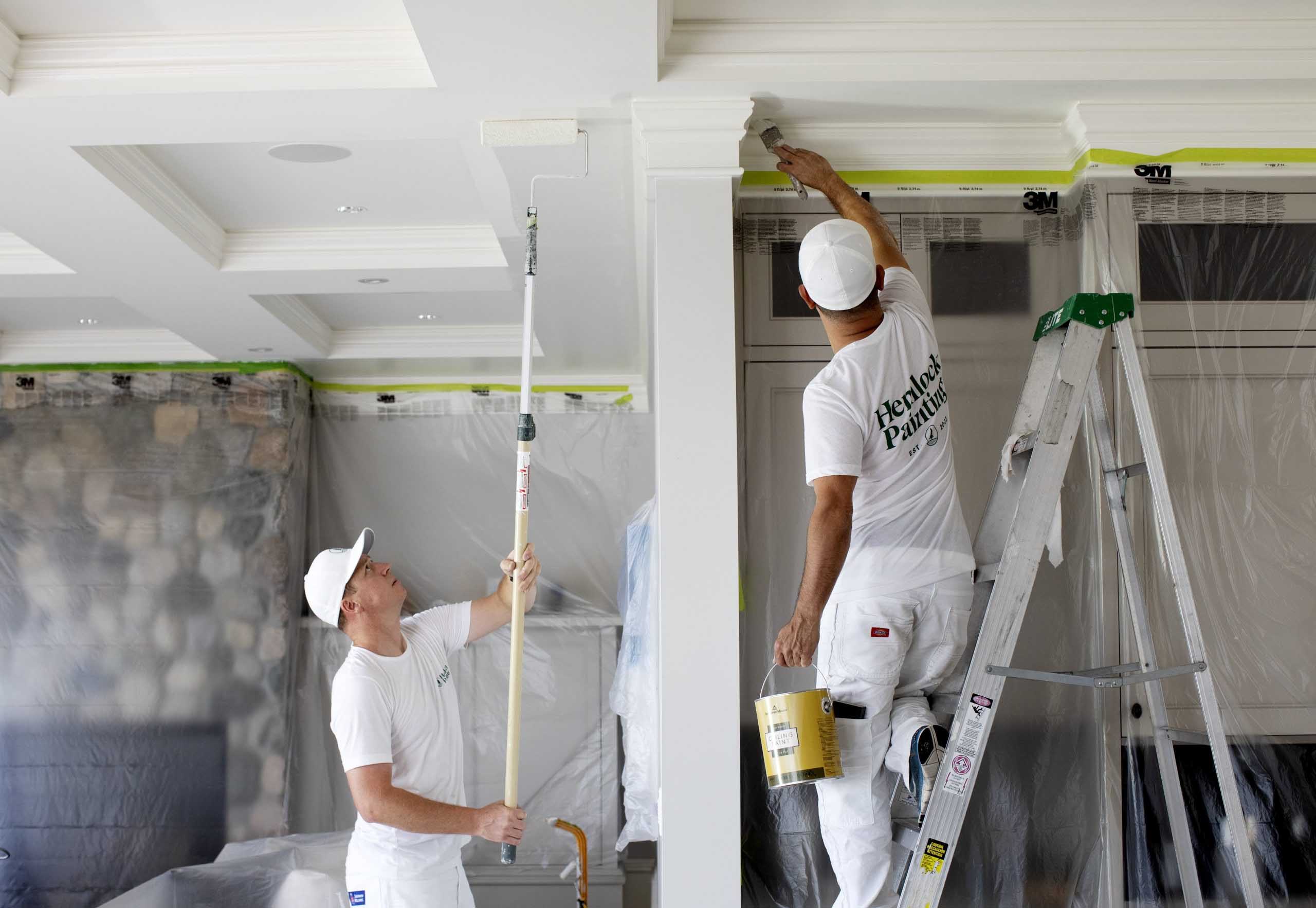 2 painters painting the ceiling